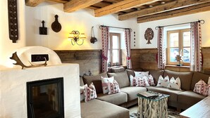 A cozy living room with a fireplace, wooden beams, and a sofa set. - st martin chalets by Interhome (Sankt Michael im Lungau)