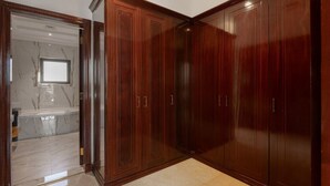A room with a large wooden wardrobe, a marble-tiled floor, and a doorway leading to another room. - Villa on Beach w/ Private Pool The Palm Jumeirah (Dubai)