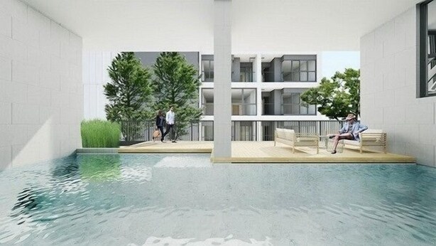 A modern indoor pool area with a clear view of a building in the background.