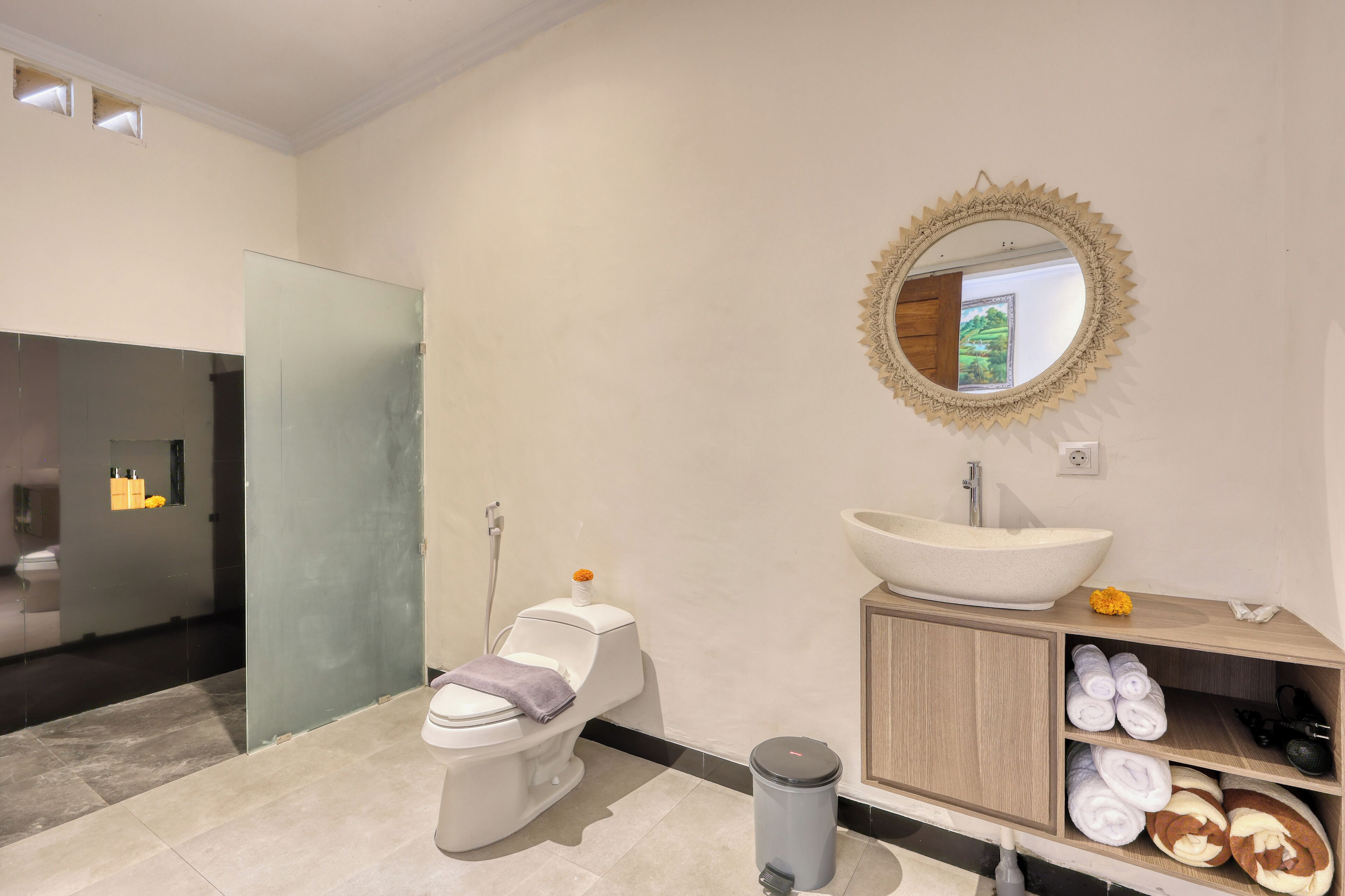 A modern bathroom with a toilet, bidet, sink, and vanity.