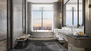Ein modernes Badezimmer mit einer großzügigen Badewanne, zwei Waschbecken und Blick auf die Stadt.