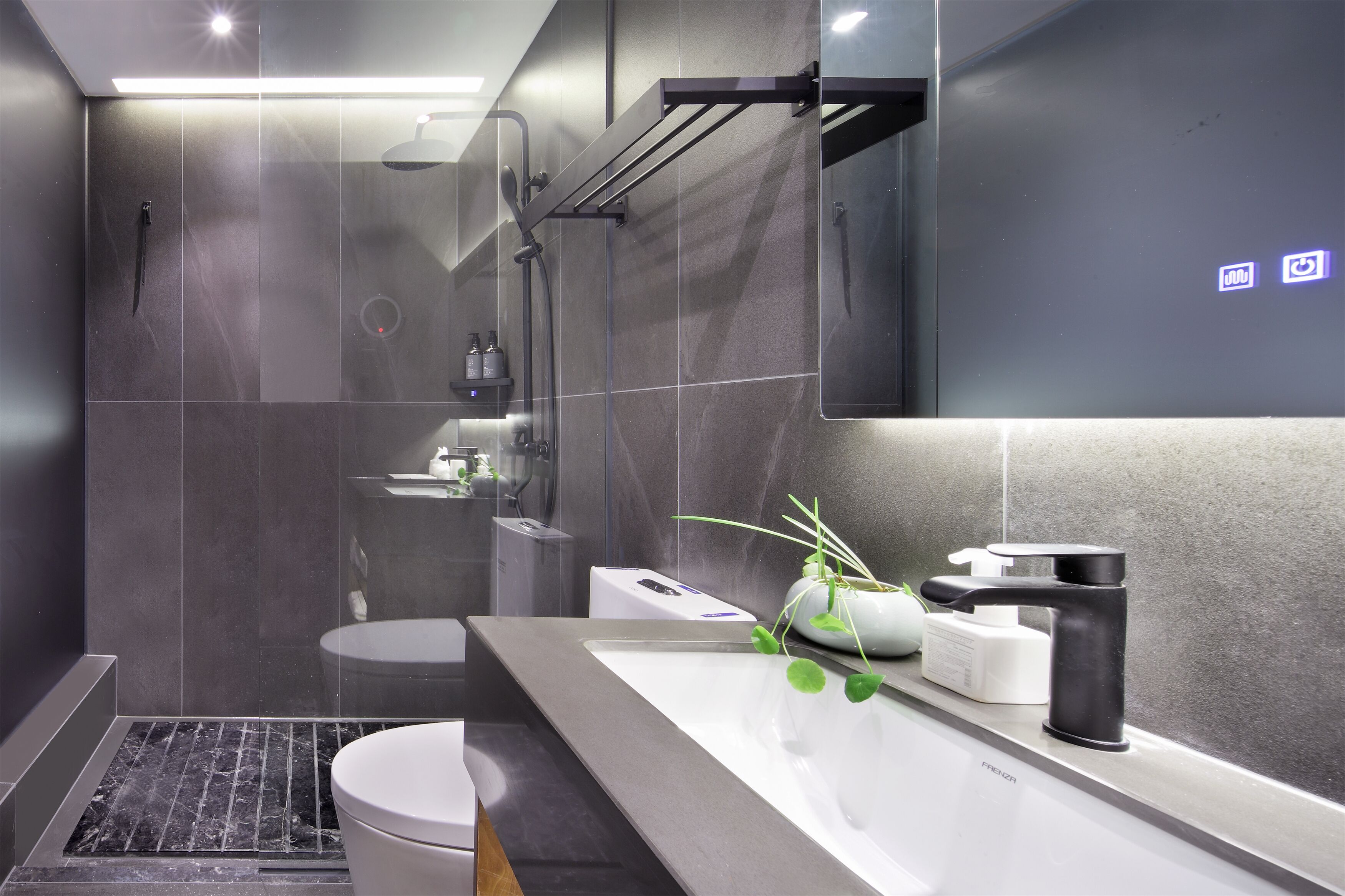 A modern bathroom with a glass shower enclosure, a white sink with a black faucet, and a mirror above the sink.