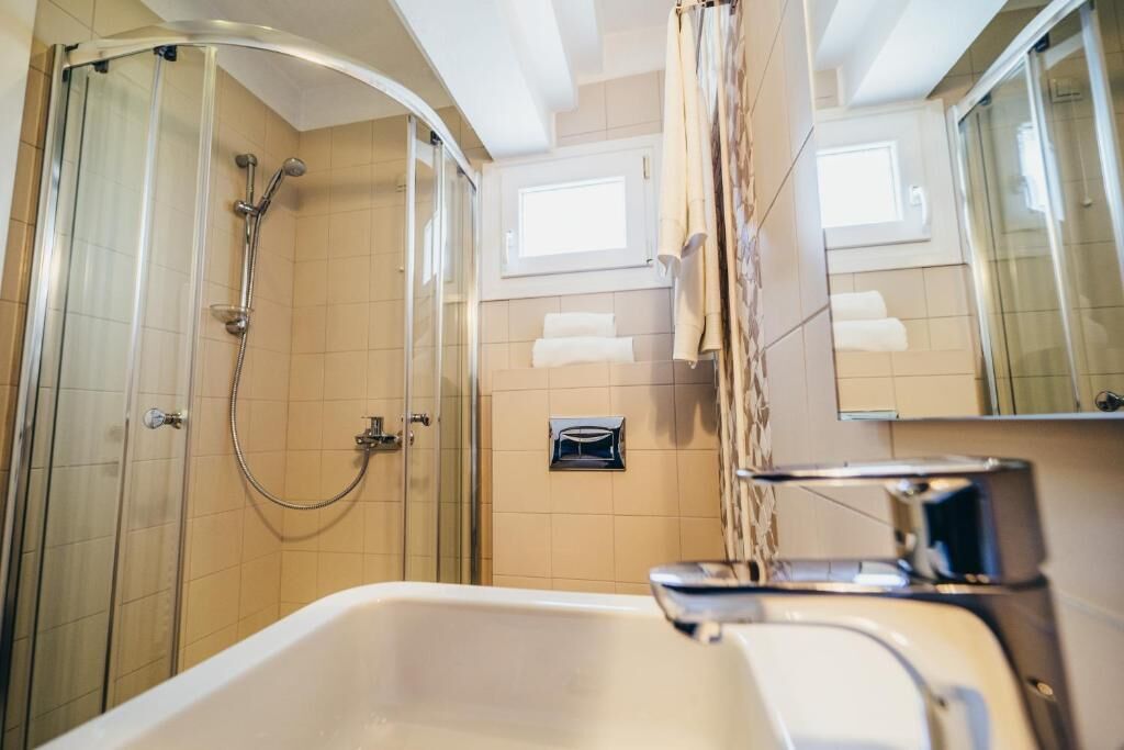 Un baño con ducha envuelta en vidrio, bañera y espejo.