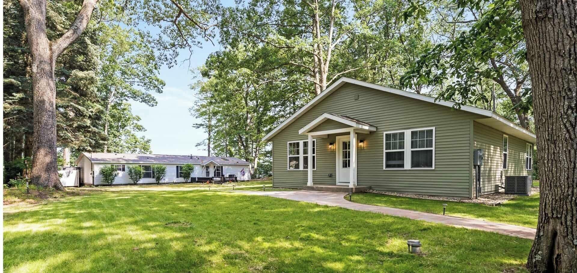 A single-story house with a front porch, a small attached garage, and a well-maintained lawn.