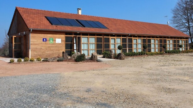 A long, single-story building with a red-tiled roof and large windows. - Family eco-cottage with garden, near hiking trail (Mesples)