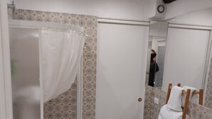 A bathroom with a shower, a sink, a toilet, and a towel rack. - In the heart of a medieval French village. One bed apartment. Pet friendly (Cipières)