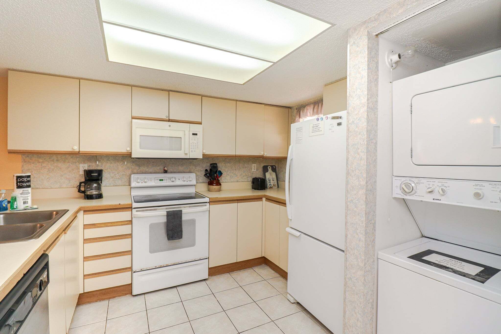 A kitchen with a microwave, stove, oven, and refrigerator.