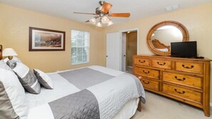 Cozy retreat with a bed, dresser, and mirror, offering a comfortable space to rest.