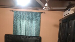 A bedroom with a bed, a ceiling fan, a window with curtains, and a wardrobe. - Beautiful 3-bed House in Serrekunda (Serrekunda)