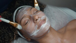 A person receiving a facial treatment with a brush. - Sanna Boutique Hotel (Arusha)