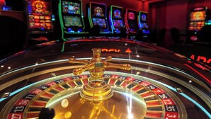 A roulette wheel with a golden handle in a casino setting. - Sanna Boutique Hotel (Arusha)