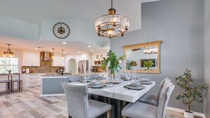 A spacious kitchen with white cabinets, a large island, and a chandelier. - Gorgeous Punta Gorda Home w/ Lanai & Private Pool! (Punta Gorda)