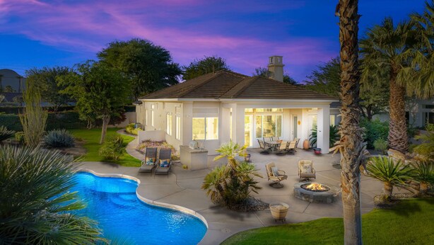 A house with a swimming pool, patio furniture, and a well-maintained garden. - Private Pool Home in Highly Sought After Mountain View Country Club (La Quinta)