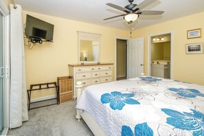 A bedroom with a bed, dresser, ceiling fan, and a television. - South Shore Sea Esta - 5 BR Second Row Home - Pool & Kiddie Pool (Surf City)