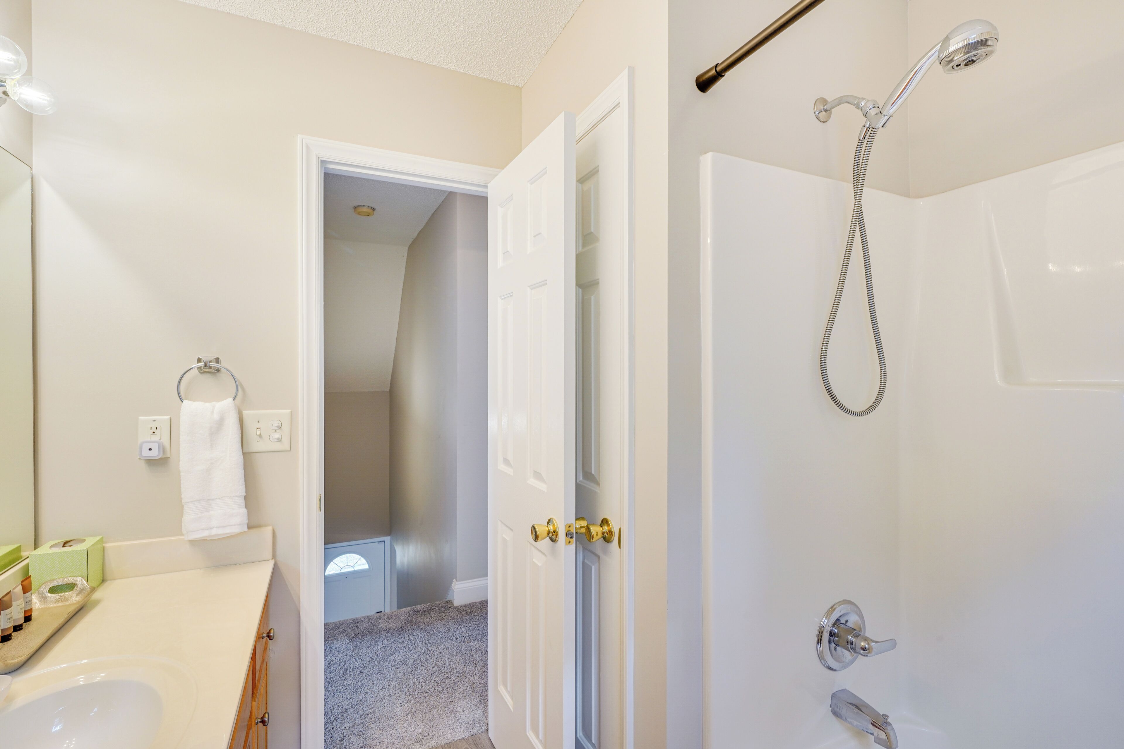 A bathroom with a sink, toilet, and shower.