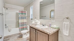 A bathroom with a bathtub, toilet, and sink. - Pet-friendly Home ~ 10 Mi to Hocking Hills! (Laurelville)