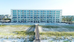 A modern hotel with multiple floors, a swimming pool, and a beach area. - Luxury Beachfront Bliss – Blu’s Only 2BR Condo! (Fort Walton Beach)
