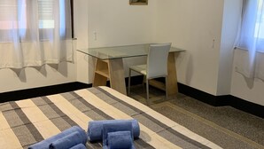 A hotel room with a bed, a glass table, two chairs, and two framed pictures on the wall. - Violetta Portofino by PortofinoVacanze  (Rapallo)
