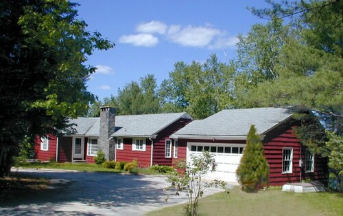 Family compound on Thomas Pond featuring main house and two small cottages.