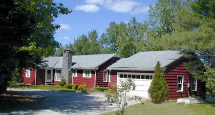 Family compound on Thomas Pond featuring main house and two small cottages.