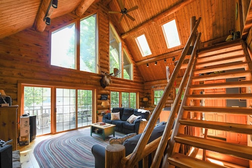 Spacious log cabin with 600' of water frontage on picturesque Moose Pond.