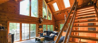 Spacious log cabin with 600' of water frontage on picturesque Moose Pond.
