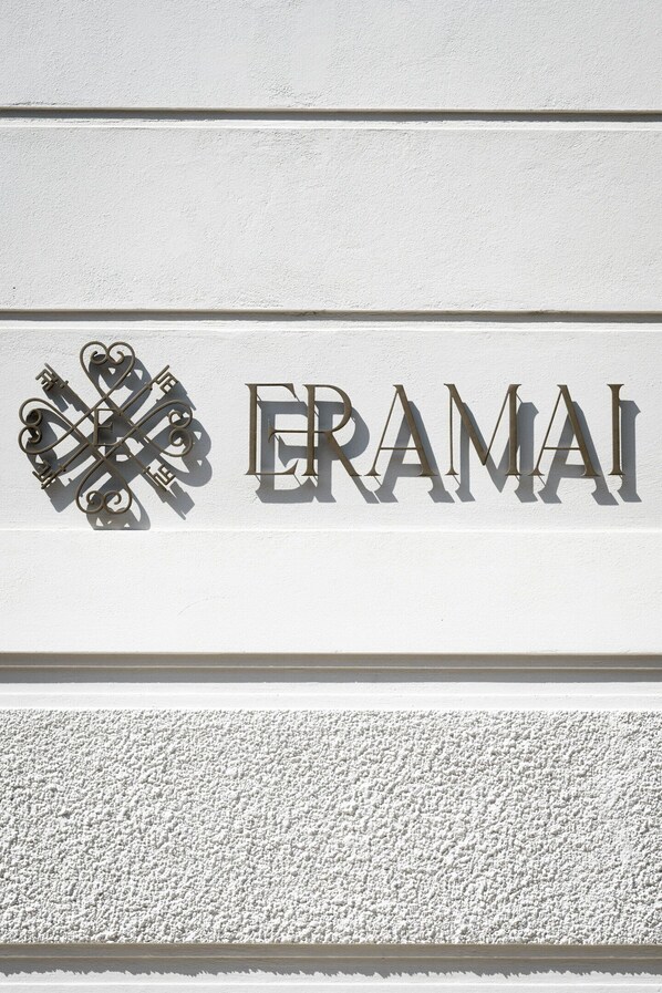 A sign with the word "ERAMAI" and a decorative key design. - ERAMAI (Patras)