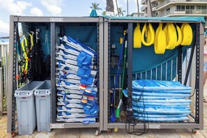 Un depósito de almacenamiento con hileras de palas, un trapeador y productos de limpieza.