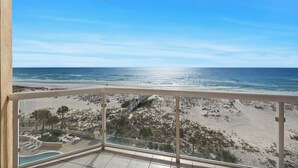 A balcony with a view of a beach and ocean. - Emerald Isle 507 The Jolly Roger🌊Beachfront Condo w/ Views + Chair Service (Pensacola Beach)