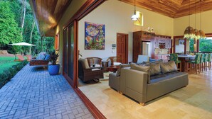 A spacious living area with a sofa, chairs, and a dining table. - Vista Sirena: Expansive Ocean View 4 bedroom / 4.5 bath home above Dominical (Puntarenas Province)