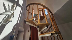 A wooden spiral staircase with a white railing, leading to an upper floor. - MARE FUORI - Studio Apartment with Terrace (Rovinj)