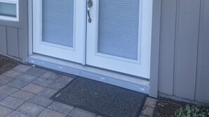 A double door with a glass panel and a keypad lock.