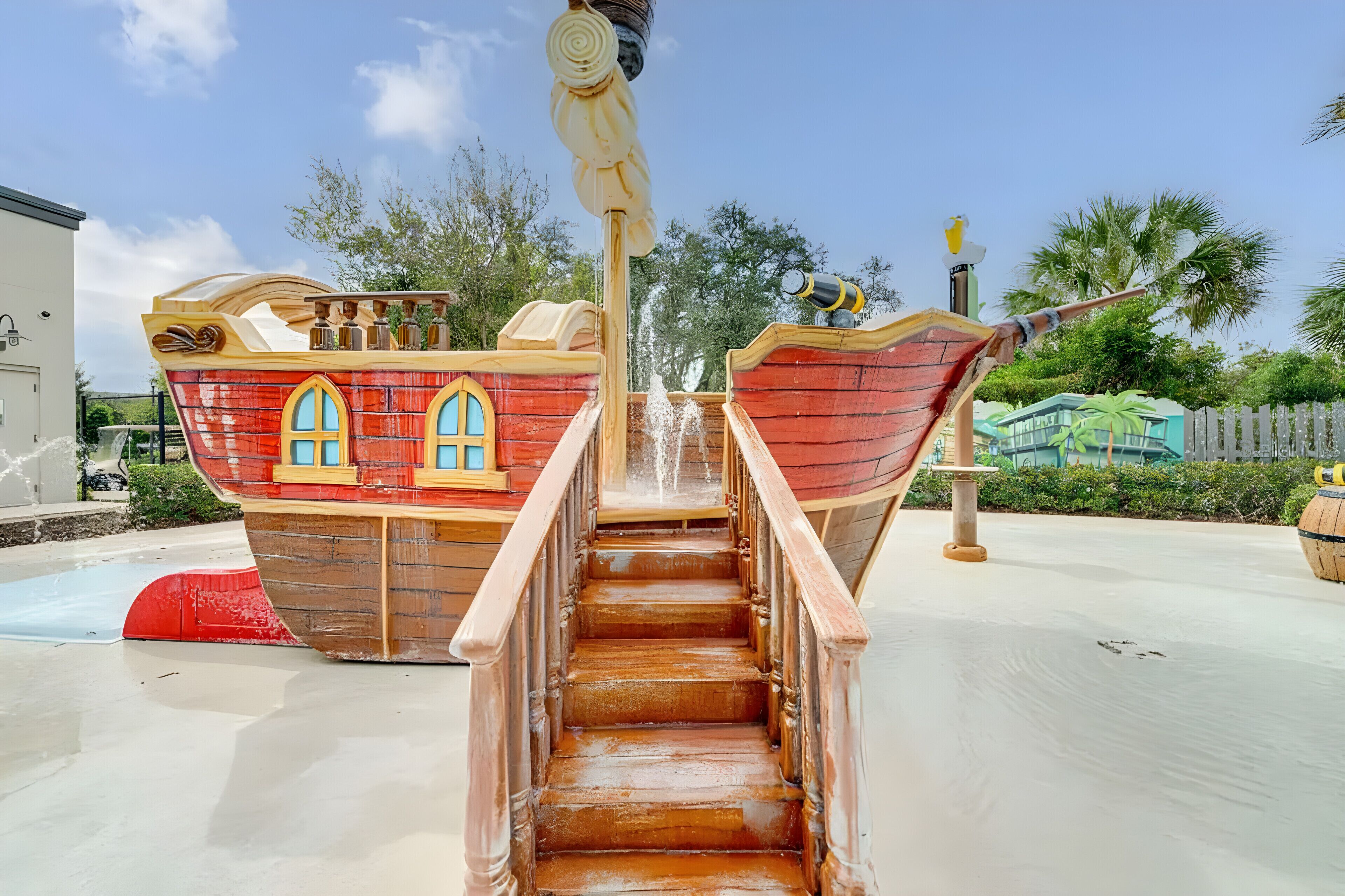 A wooden staircase leading up to a ship-shaped water feature with a water spout.