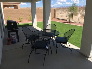 A patio with a grill, chairs, and a small table. - VIEW, NEWER HOME NEAR COLORADO RIVER, GOLF, SHOPPING, ATV TRAILS (Fort Mohave)