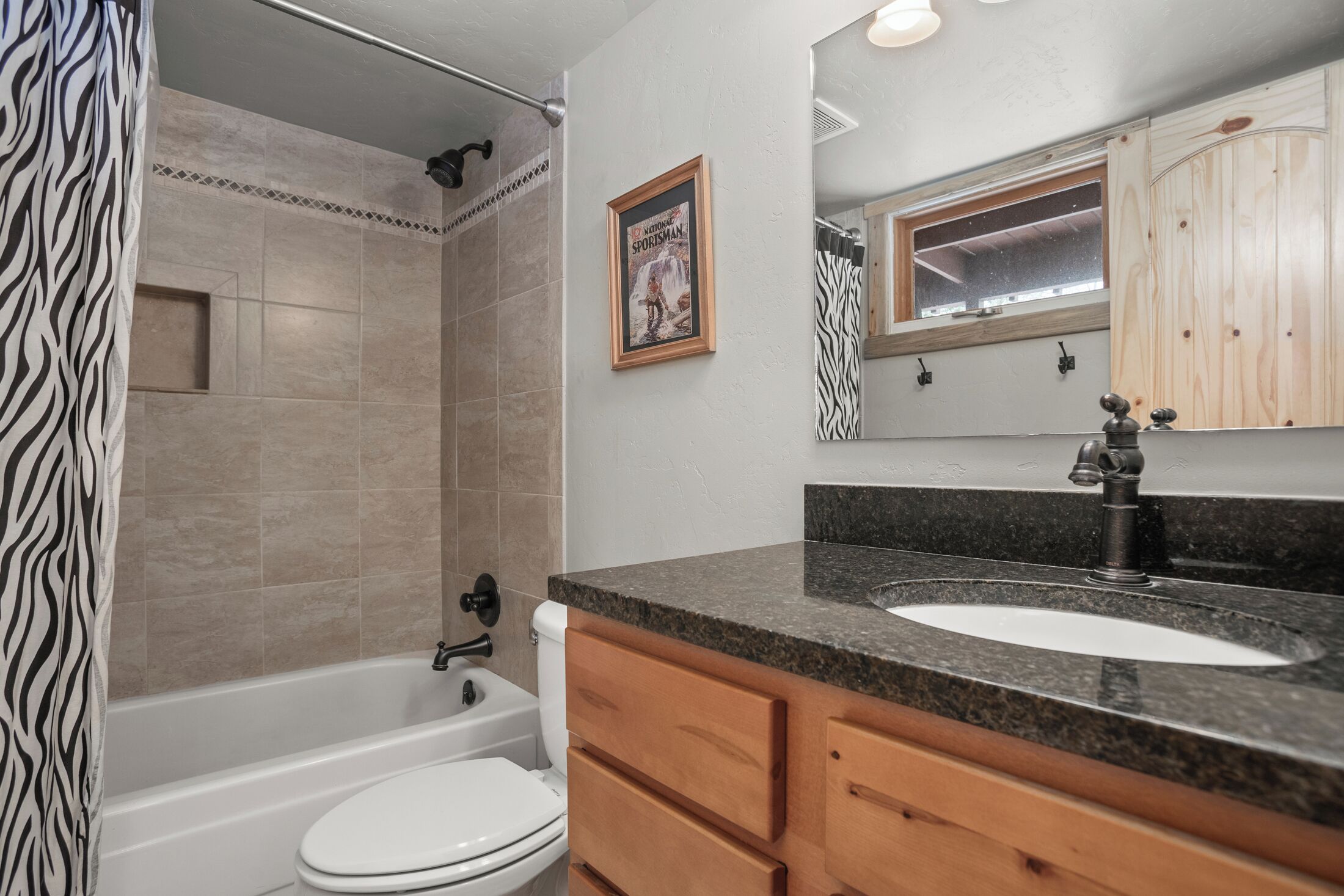 A bathroom with a bathtub, toilet, and sink.