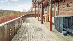 A wooden deck with a view of hills, a grill, and a lantern. - 7 bedroom awesome home in Tjørhom (Tjørhom)