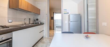 Fridge, stovetop, dishwasher, coffee/tea maker