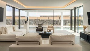 A modern living room with a sofa, armchairs, and a coffee table. - AVASARALA by Buenavilla | A 3 bedroom luxury villa in Puerto Calero (Puerto Calero)