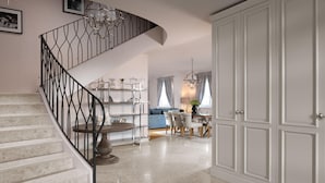 A modern interior with a curved staircase, a dining area, and a large wardrobe. - Gorgeous home in Vabriga (Vabriga)