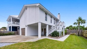 A two-story house with a covered porch and a garage. - Bid-A-Wee Beach Home-Private Pool (Panama City Beach)