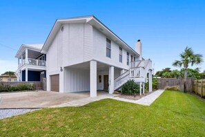 A two-story house with a covered porch and a garage. - Bid-A-Wee Beach Home-Private Pool (Panama City Beach)