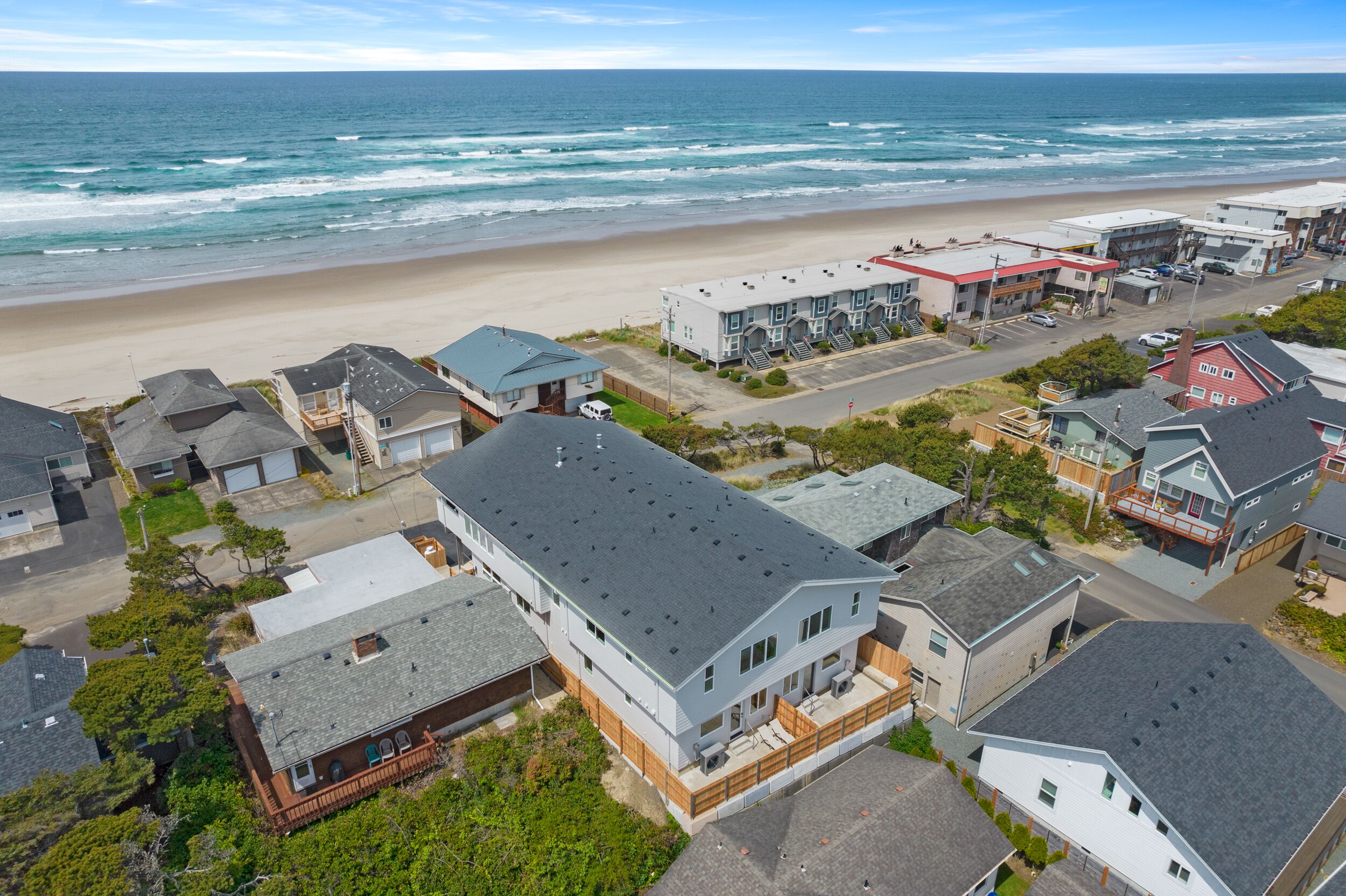 A coastal residential area with houses, a beach, and ocean views.