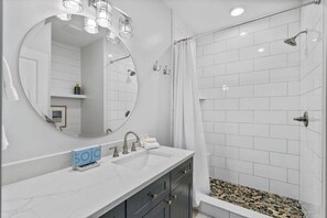 Shower, hair dryer, towels, shampoo