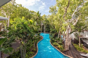 A pool surrounded by lush greenery and trees, with a clear blue pool water. - Serenity @ Drift Beach Resort - Palm Cove (Palm Cove)