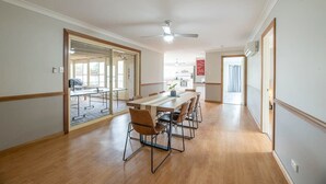 A spacious room with a long dining table, chairs, and a ceiling fan. - Windsor. Backyard Entertainer. Dubbo. (Dubbo)