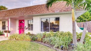 A single-story house with a brick roof and a white exterior. - Beachside Cottage - 5 min walk to the Beach (Cocoa Beach)
