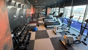 A gym with treadmills, dumbbells, and exercise balls. - msharef almoden hotel (Riyadh)