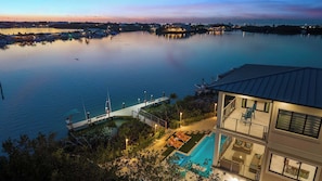 A waterfront property with a pool, a dock, and a view of the water. - Luxury Seaside Escape ~ Pool ~ Dock ~ Scenic Views (Marathon)