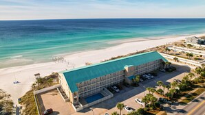 A beachfront hotel with a swimming pool, multiple parking levels, and a view of the ocean. - Crystal Sands110A • Luxe Remodel, Steps to the Sand (Destin)