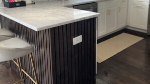 A modern kitchen with a central island, white cabinetry, a herringbone-patterned backsplash, and a pendant light. - Private Room &Bathroom, Quaint Beach Town, Free local beaches, Ferry to NYC (Highlands)